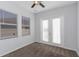 Bright bedroom featuring neutral carpet with two large windows and a glass door at 7327 Brightwaters Ct, New Port Richey, FL 34652