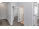 Hallway featuring carpet, doors leading to rooms and a closet at 7327 Brightwaters Ct, New Port Richey, FL 34652