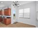 Eat-in kitchen featuring granite countertops, stainless sink, wood cabinets and a door leading to a balcony at 7327 Brightwaters Ct, New Port Richey, FL 34652