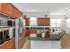 Modern kitchen with stainless steel appliances, granite countertops and wood cabinetry at 7327 Brightwaters Ct, New Port Richey, FL 34652