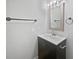 Bathroom with dark vanity, modern fixtures, and a decorative mirror at 9481 Highland Oak Dr # 703, Tampa, FL 33647