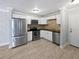 Modern kitchen with stainless steel appliances, white cabinets, and tile flooring at 9481 Highland Oak Dr # 703, Tampa, FL 33647