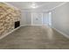 Spacious living room featuring a brick fireplace, tile floors, and white trim at 9481 Highland Oak Dr # 703, Tampa, FL 33647