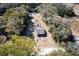 Aerial view of a wooded property featuring a single-story home and a tree-lined perimeter at 19100 Leland Ave, Spring Hill, FL 34610