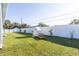 Expansive backyard with lush green grass, a white fence, playhouse, and ample space for recreation at 357 Rallus Rd, Venice, FL 34293