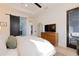 Bright main bedroom with sliding barn door to ensuite bathroom and direct access to a balcony at 357 Rallus Rd, Venice, FL 34293