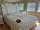 Bright bedroom featuring a large bed with white bedding, side tables, and natural light at 1813 Mariner Dr # 152, Tarpon Springs, FL 34689