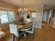Inviting dining area with stylish chandelier, wood floors, and natural light from nearby window at 1813 Mariner Dr # 152, Tarpon Springs, FL 34689