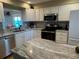 Well-lit kitchen featuring updated appliances, neutral countertops, and ample cabinet space for storage at 1813 Mariner Dr # 152, Tarpon Springs, FL 34689