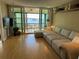 Spacious living room with sliding glass doors leading to a balcony and waterfront view at 1813 Mariner Dr # 152, Tarpon Springs, FL 34689