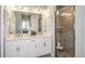 Modern bathroom with double vanity, sleek fixtures, and a glass-enclosed shower at 23819 Collina Way # 011101, Port Charlotte, FL 33980