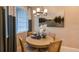 Cozy dining area with natural light, modern chandelier, and a table setting for four at 23819 Collina Way # 011101, Port Charlotte, FL 33980