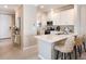 Bright kitchen with white cabinets, stainless steel appliances, and a breakfast bar with seating at 23819 Collina Way # 011101, Port Charlotte, FL 33980