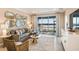Comfortable living room with stylish decor, neutral tones, leading to a scenic outdoor view at 23819 Collina Way # 011101, Port Charlotte, FL 33980