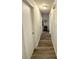 Hallway showcasing wood-look flooring and white walls, leading to multiple rooms at 5124 Brookmeade Dr, Sarasota, FL 34232