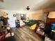 A living room filled with furniture and boxes, featuring wood floors and a doorway at 5124 Brookmeade Dr, Sarasota, FL 34232