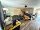 A living room filled with furniture and boxes, featuring wood floors at 5124 Brookmeade Dr, Sarasota, FL 34232