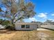 Backyard featuring mature tree, offering natural shade and a peaceful outdoor space at 4508 Golfwood Blvd, Tampa, FL 33634