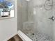 Updated shower stall with attractive stone tile and a corner shelf, with a window at 4508 Golfwood Blvd, Tampa, FL 33634