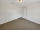 Bedroom with neutral carpet, white walls and a closet with mirrored doors at 4508 Golfwood Blvd, Tampa, FL 33634