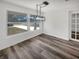 Dining room featuring hardwood floors, an industrial-style light fixture and a window at 4508 Golfwood Blvd, Tampa, FL 33634