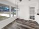 Dining room featuring hardwood floors, a modern light fixture and a large window at 4508 Golfwood Blvd, Tampa, FL 33634