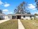 Charming single-story home featuring a brick facade and well-manicured lawn, offering classic curb appeal at 4508 Golfwood Blvd, Tampa, FL 33634