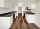 Modern kitchen featuring sleek white cabinets, stainless steel appliances, and attractive wood-look flooring at 4508 Golfwood Blvd, Tampa, FL 33634