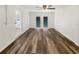Living room featuring hardwood floors, a ceiling fan and French doors to backyard at 4508 Golfwood Blvd, Tampa, FL 33634