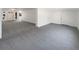 Spacious living room featuring neutral carpet, white walls and a white door at 4508 Golfwood Blvd, Tampa, FL 33634
