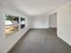 Living room featuring neutral carpet, white walls and a large window at 4508 Golfwood Blvd, Tampa, FL 33634