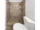 Tiled shower stall, featuring neutral tiles and a complementary shower fixture at 4508 Golfwood Blvd, Tampa, FL 33634