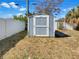 Backyard storage shed with a secure door and ample space, perfect for organization and outdoor storage solutions at 4508 Golfwood Blvd, Tampa, FL 33634