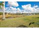 Backyard view showing small pond and nearby homes at 11530 57Th Street E Cir, Parrish, FL 34219