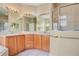 Bright bathroom featuring a double sink vanity, framed mirrors, and a glass enclosed shower at 11530 57Th Street E Cir, Parrish, FL 34219