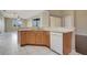 Bright kitchen with tile floor and stainless steel dishwasher at 11530 57Th Street E Cir, Parrish, FL 34219