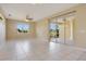 Spacious living room featuring bright tile floors, a ceiling fan, and large windows at 11530 57Th Street E Cir, Parrish, FL 34219