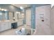 Bright bathroom features a double vanity, large shower with a bench, and a soaking tub at 29930 Radice Ct, Wesley Chapel, FL 33545