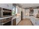 Modern kitchen featuring white cabinets, stainless steel appliances, and ample counter space for cooking and prep at 29930 Radice Ct, Wesley Chapel, FL 33545