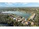 Panoramic aerial view of a lakeside neighborhood with lush green trees at 6977 74Th Street E Cir, Bradenton, FL 34203