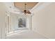 Bright bedroom with tray ceiling, fan, and a view of the pool outside at 6977 74Th Street E Cir, Bradenton, FL 34203