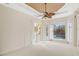 Bedroom featuring tray ceiling, fan, and sliding door access to the patio at 6977 74Th Street E Cir, Bradenton, FL 34203