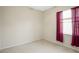 Empty bedroom with window and red curtains at 6977 74Th Street E Cir, Bradenton, FL 34203