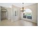 Bright dining area featuring a chandelier and a large window with views of the outdoors at 6977 74Th Street E Cir, Bradenton, FL 34203