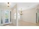 Inviting foyer and dining area with chandelier lighting and arched entryways at 6977 74Th Street E Cir, Bradenton, FL 34203