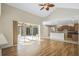 Bright and airy living room featuring hardwood floors, vaulted ceilings, and seamless transition to a screened lanai at 6977 74Th Street E Cir, Bradenton, FL 34203