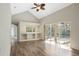 Bright living room with wood-look tile flooring and sliding doors to the outdoor pool area at 6977 74Th Street E Cir, Bradenton, FL 34203