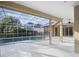 Enclosed pool area featuring concrete decking and ceiling fans for a relaxing atmosphere at 6977 74Th Street E Cir, Bradenton, FL 34203