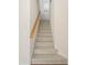 Carpeted staircase with wooden handrail at 6977 74Th Street E Cir, Bradenton, FL 34203