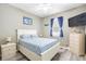 Bedroom featuring queen bed, ceiling fan, neutral color scheme, and ample natural light at 2734 Ashland Ln, North Port, FL 34286